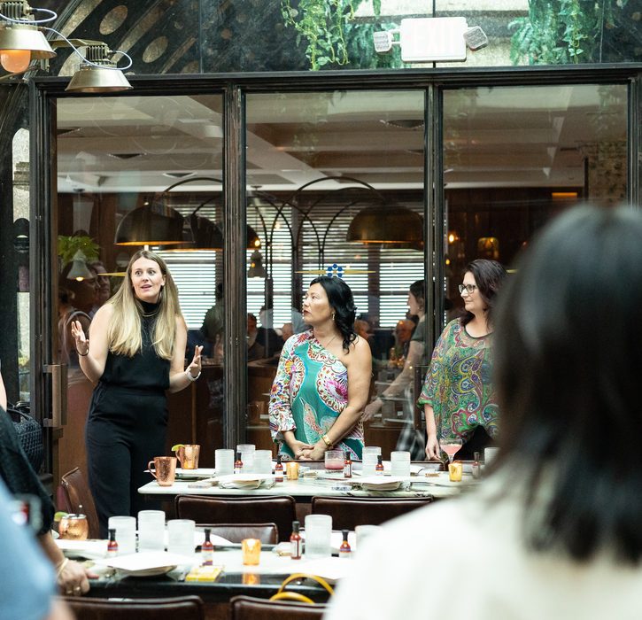 A group of fieldwork employees talking in a dining hall