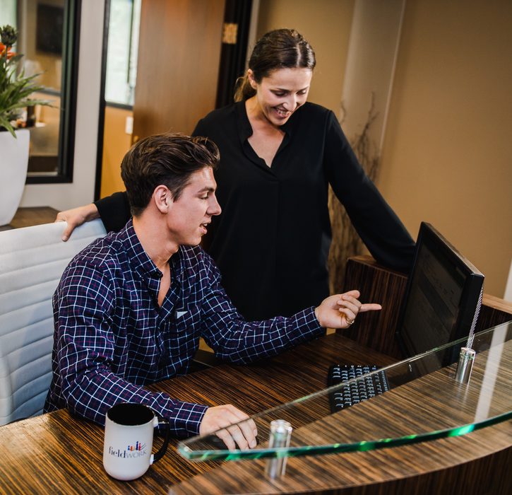 Man and a woman looking at a computer