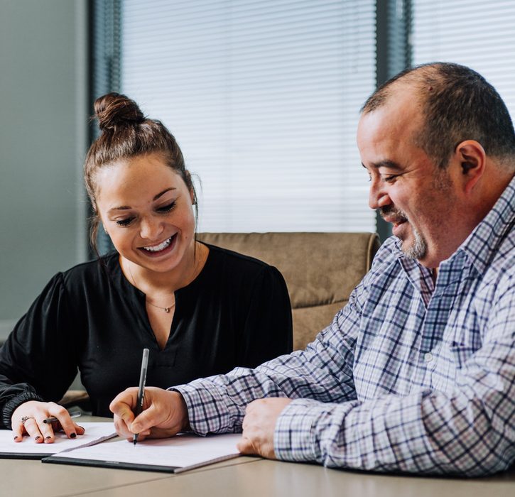 Man and a woman signing papers