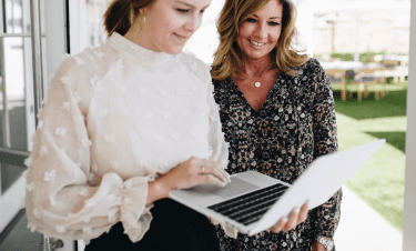 two women looking at a laptop